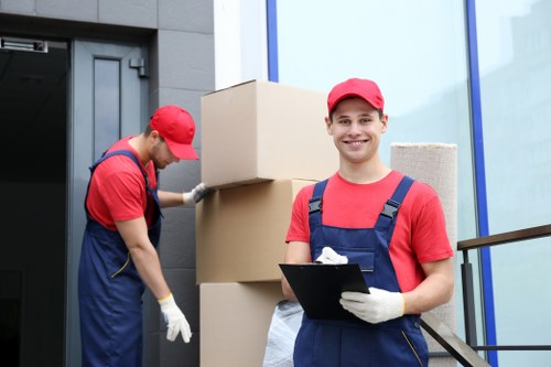 Local movers handling furniture and boxes at a Crystal Palace property