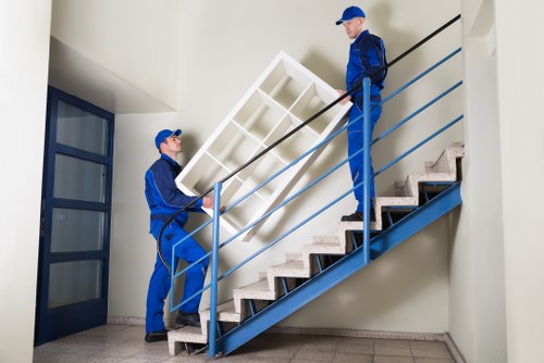 Local removals crew handling office equipment in a Crystal Palace building